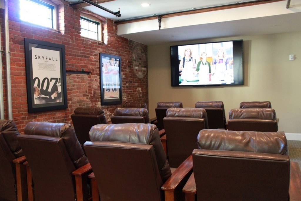 64 Beacon Street, Unit A307 Worcester, MA 01608 - Photo 20 of 23 a media room with lots of chairs and a projector