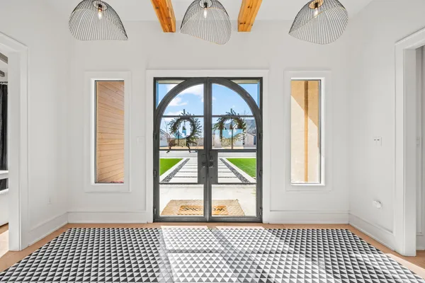 a bedroom with a bed and a chandelier