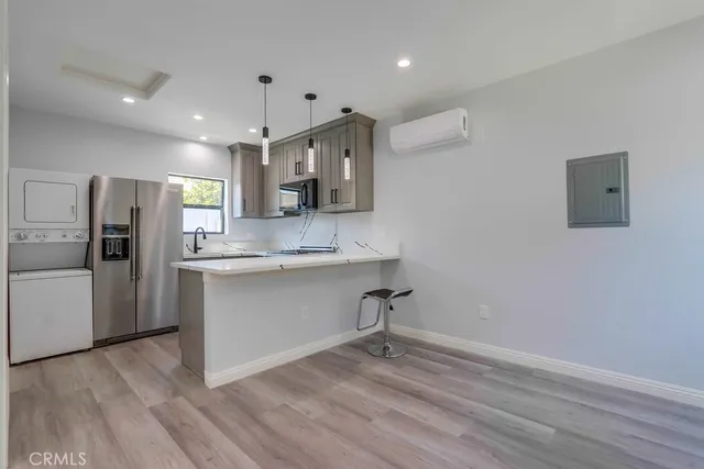 a kitchen with a refrigerator and a sink