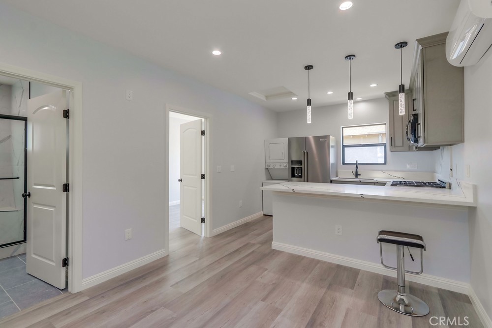 1260 East Turin Avenue, Unit B Anaheim, CA 92805 - Photo 4 of 14 a large white kitchen with a refrigerator a sink stainless steel appliances and cabinets