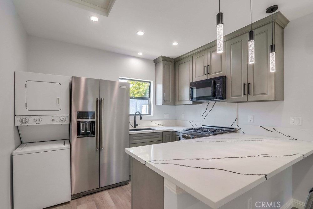 1260 East Turin Avenue, Unit B Anaheim, CA 92805 - Photo 5 of 14 a kitchen that has a sink cabinets and stainless steel appliances