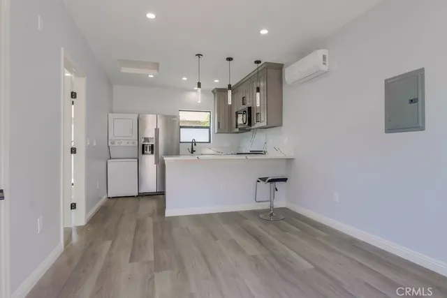 a view of kitchen with wooden floor and electronic appliances