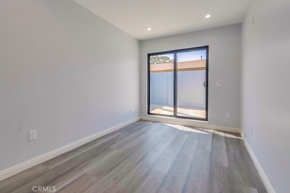 1260 East Turin Avenue, Unit B Anaheim, CA 92805 - Photo 8 of 14 wooden floor in an empty room with a window