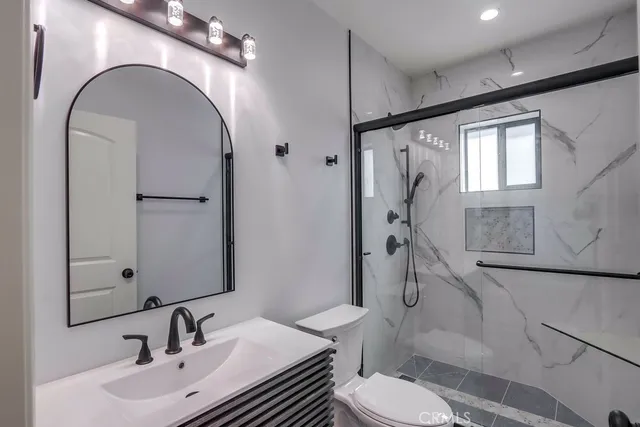 a bathroom with a sink toilet and shower