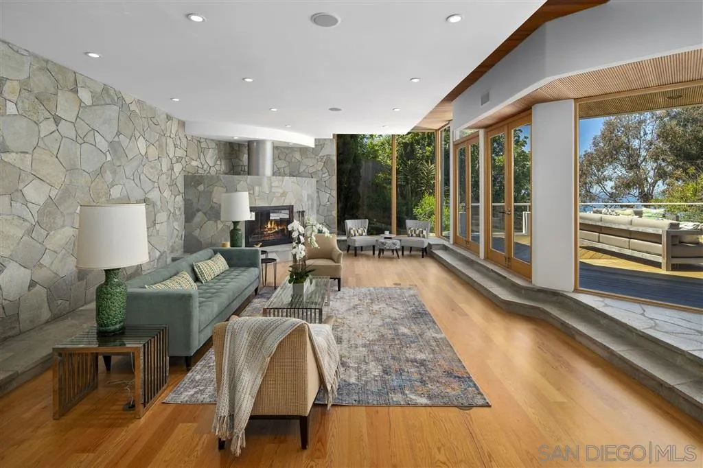 7510 Hillside Drive La Jolla, CA 92037 - Photo 11 of 25 a living room with furniture large windows and wooden floor