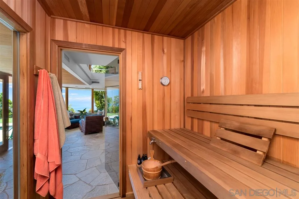 7510 Hillside Drive La Jolla, CA 92037 - Photo 22 of 25 a hallway with a couch and a potted plant