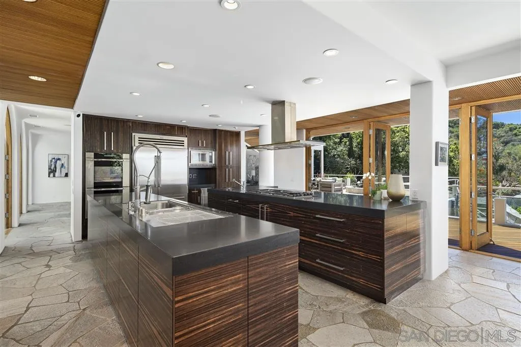 7510 Hillside Drive La Jolla, CA 92037 - Photo 9 of 25 a kitchen with stainless steel appliances granite countertop a refrigerator and a stove