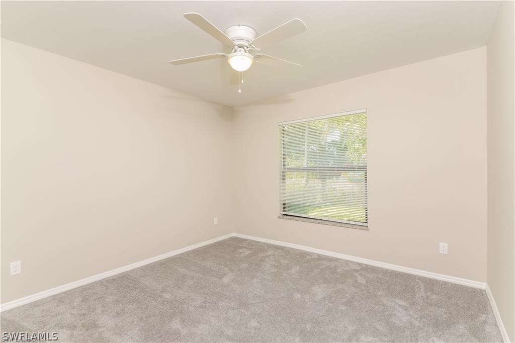 8441 Robin Road Fort Myers, FL 33967 - Photo 12 of 14 an empty room with a window and a fan