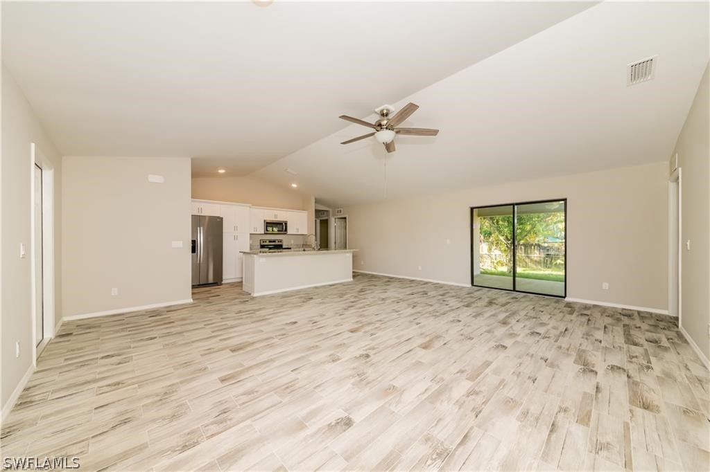 8441 Robin Road Fort Myers, FL 33967 - Photo 3 of 14 a view of empty room with wooden floor and window