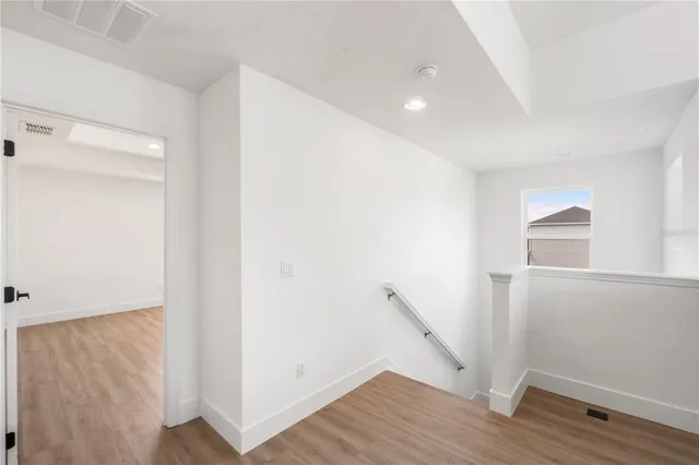 a view of hallway with wooden floor