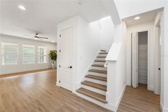 a view of a room with wooden floor and windows