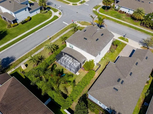 an aerial view of a house with a garden and swimming pool