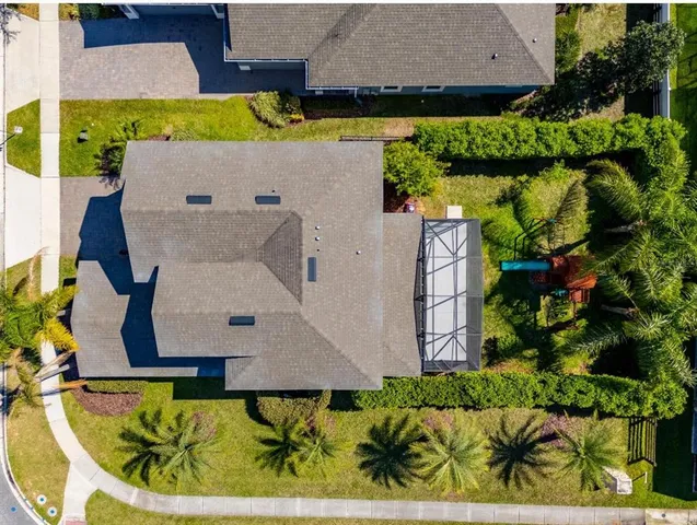 an aerial view of a house with a swimming pool