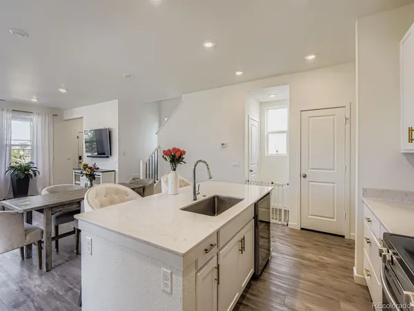 a kitchen with granite countertop a sink and a refrigerator