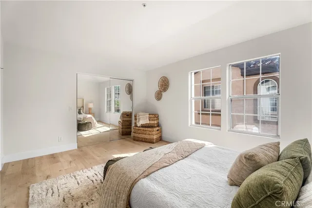 a bedroom with a bed couch and a window