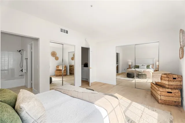 a bedroom with a bed and a large mirror