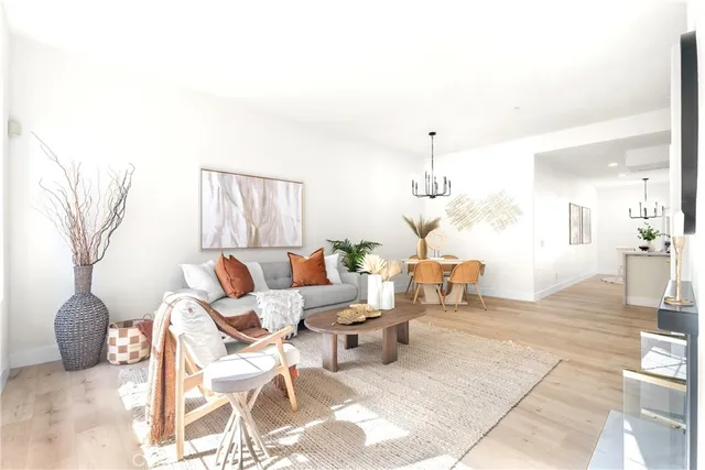 a living room with patio furniture and a chandelier