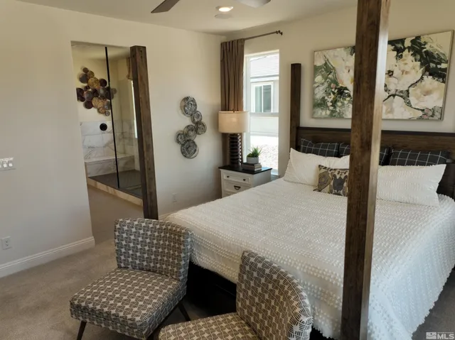 a bedroom with a bed and dresser with mirror