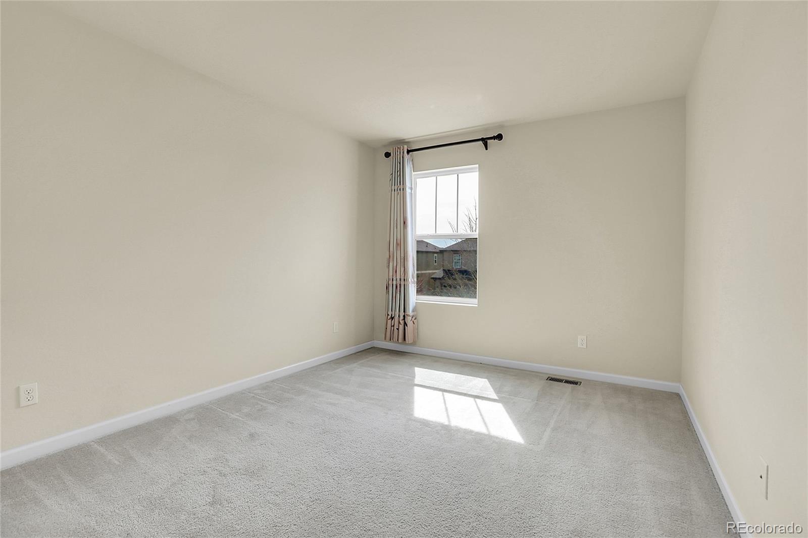 3310 Quicksilver Road Frederick, CO 80516 - Photo 17 of 35 an empty room with windows