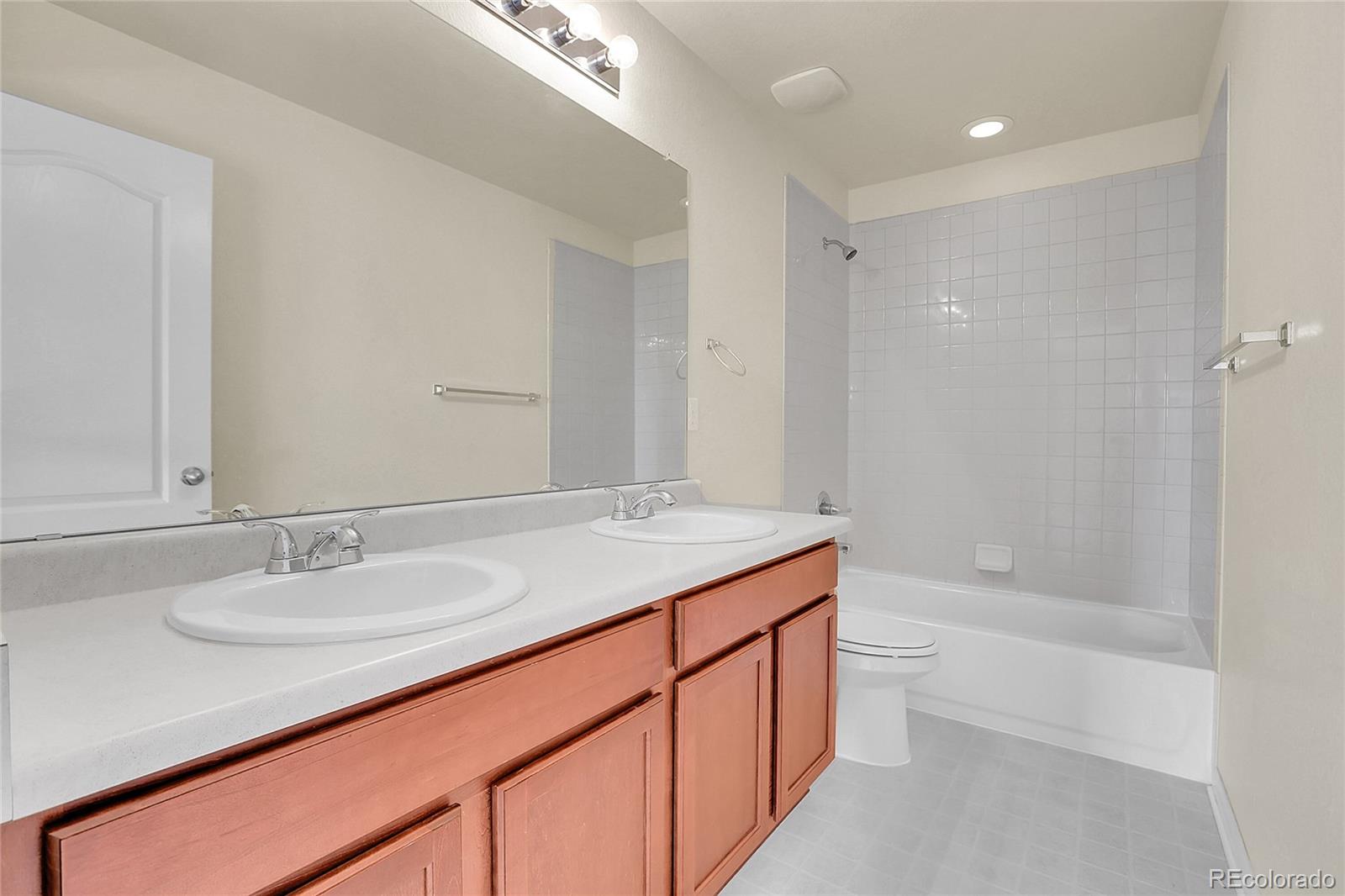 3310 Quicksilver Road Frederick, CO 80516 - Photo 18 of 35 a bathroom with a granite countertop sink a toilet and shower