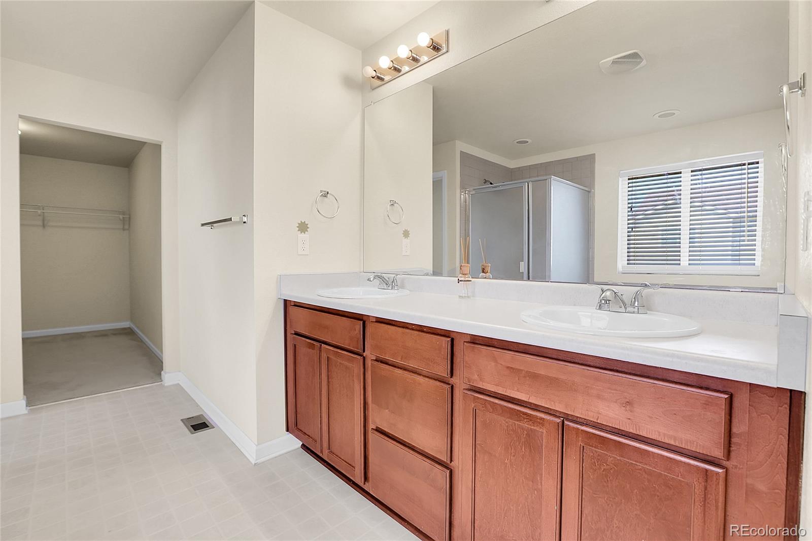 3310 Quicksilver Road Frederick, CO 80516 - Photo 20 of 35 a bathroom with a sink double vanity and a mirror