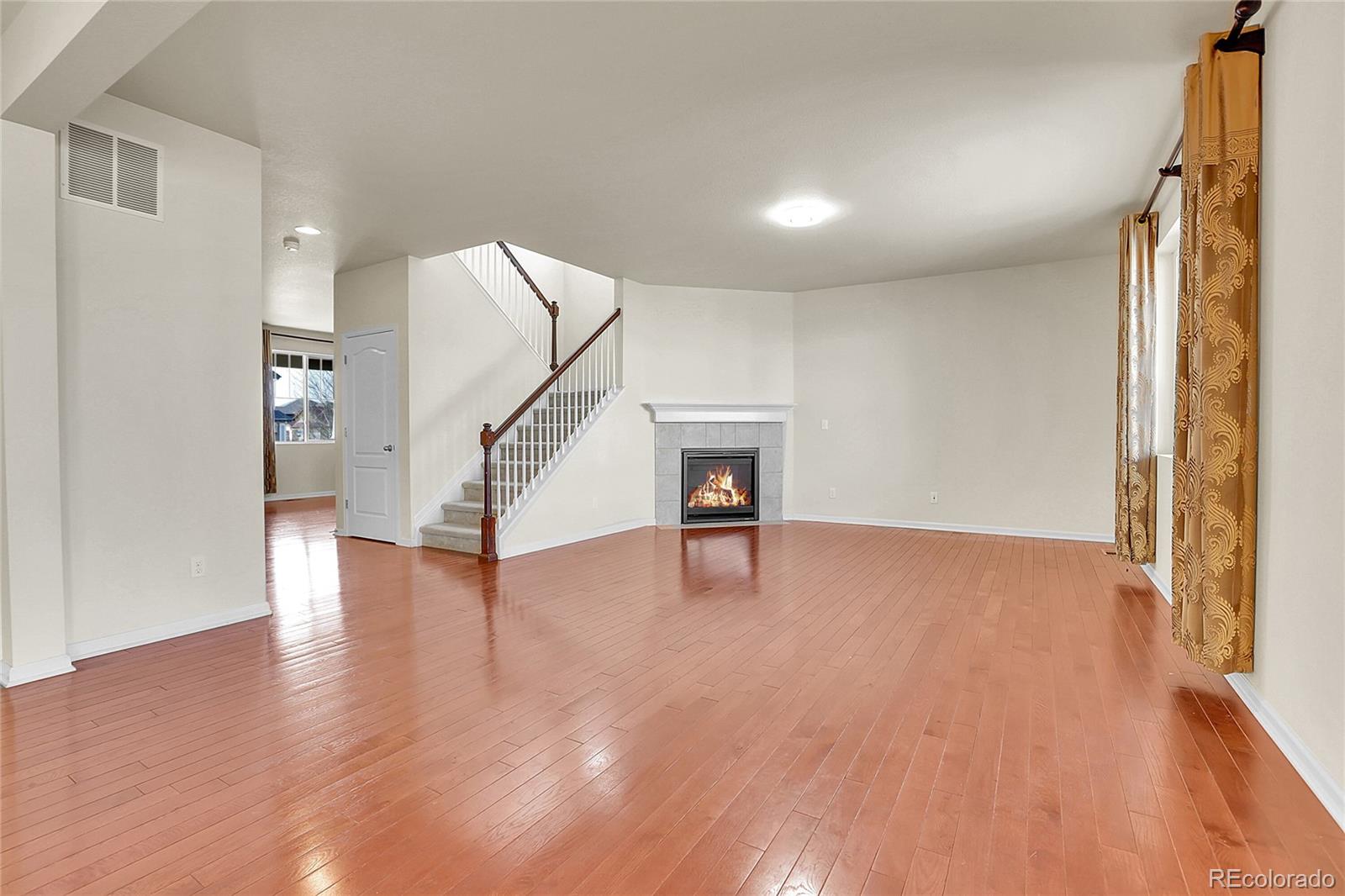 3310 Quicksilver Road Frederick, CO 80516 - Photo 3 of 35 a view of an empty room with wooden floor staircase and a living room