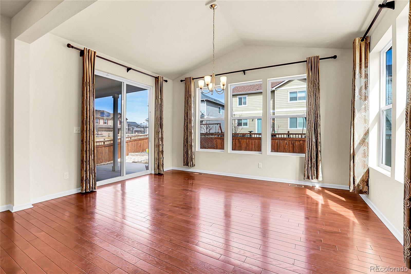 3310 Quicksilver Road Frederick, CO 80516 - Photo 9 of 35 a view of an empty room with wooden floor and a window