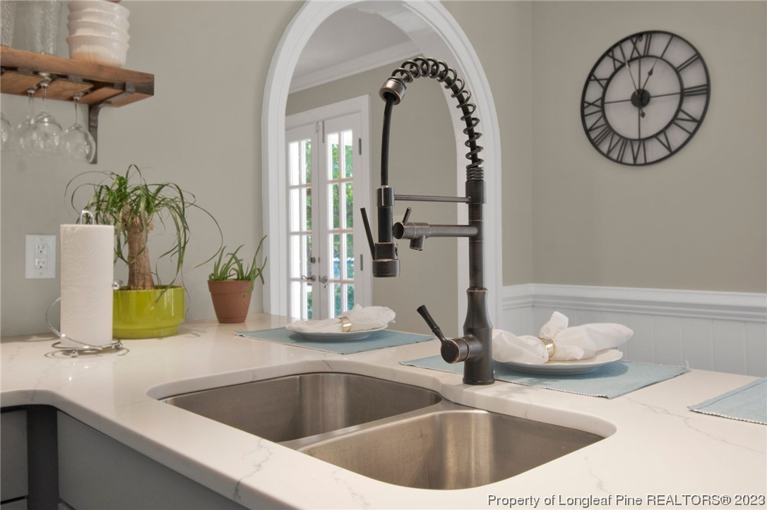 1807 Morganton Road Fayetteville, NC 28305 - Photo 11 of 37 a kitchen with a sink and a mirror
