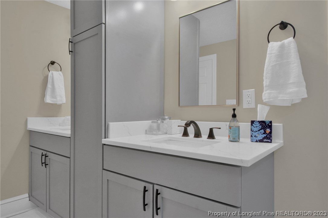 1807 Morganton Road Fayetteville, NC 28305 - Photo 17 of 37 a bathroom with a sink and a mirror