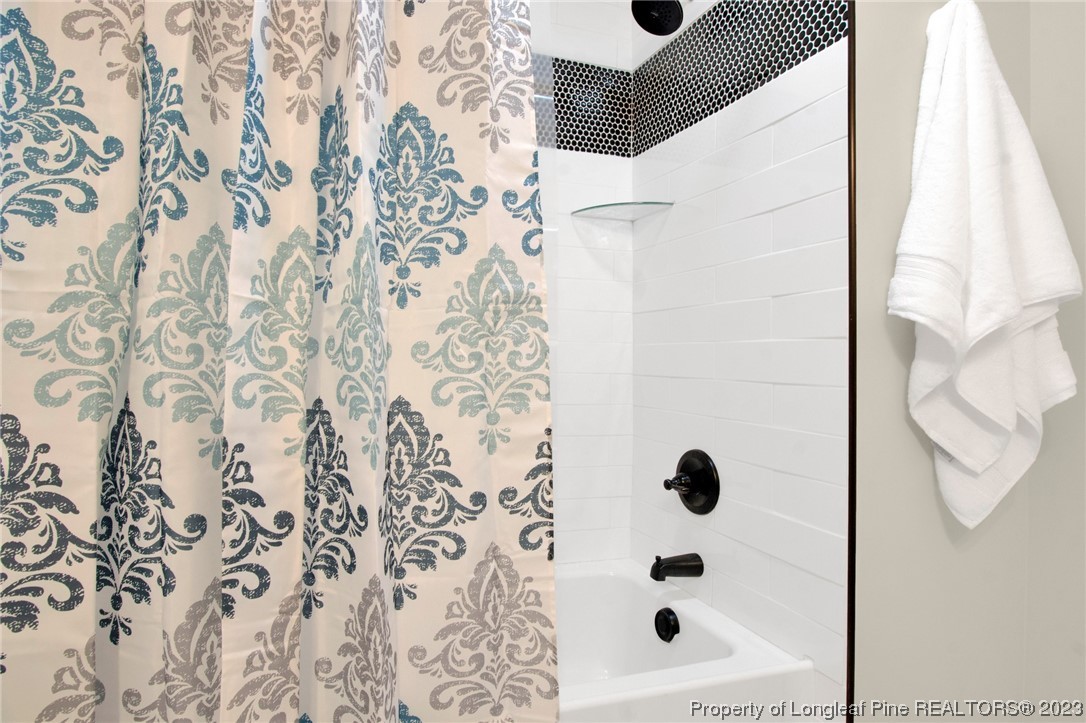 1807 Morganton Road Fayetteville, NC 28305 - Photo 18 of 37 a bathroom with a bathtub and shower