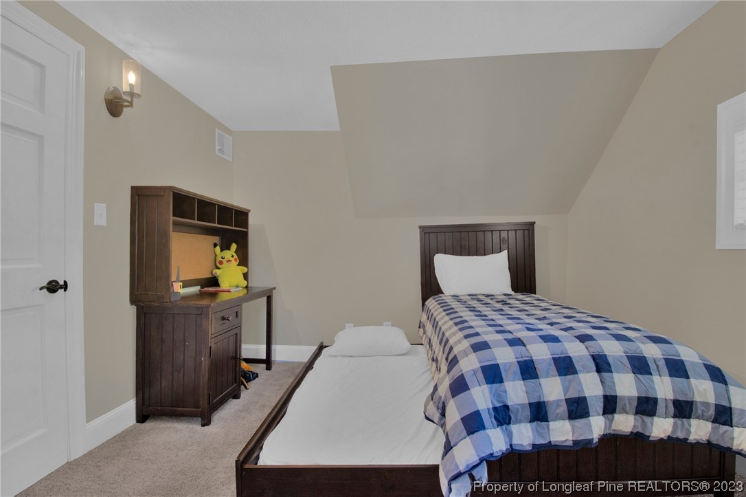 1807 Morganton Road Fayetteville, NC 28305 - Photo 20 of 37 a bedroom with a bed and wooden floor
