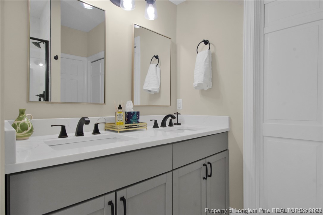 1807 Morganton Road Fayetteville, NC 28305 - Photo 25 of 37 a bathroom with a sink and mirror