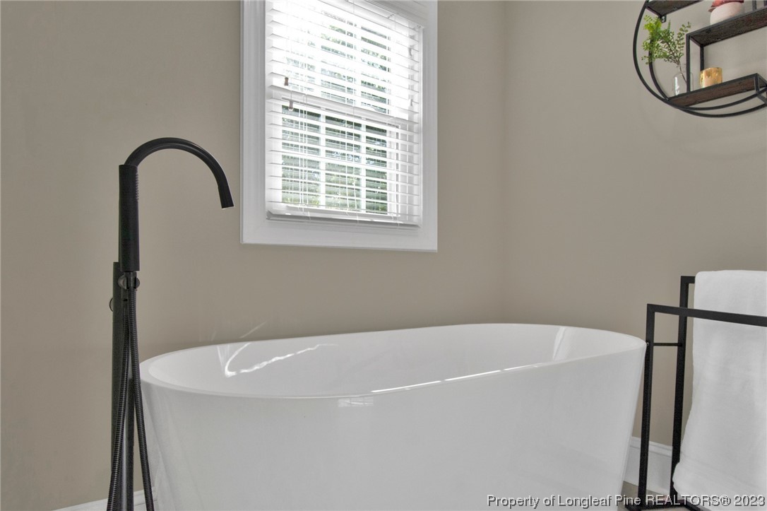 1807 Morganton Road Fayetteville, NC 28305 - Photo 26 of 37 a white bath tub sitting next to a window