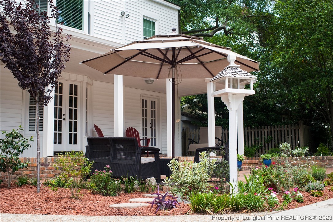 1807 Morganton Road Fayetteville, NC 28305 - Photo 33 of 37 a view of a chair and table with umbrella in front of house