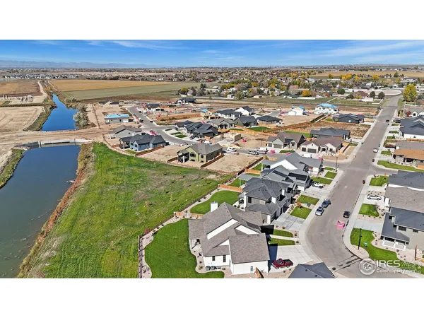 a aerial view of a house with outdoor space and a lake view