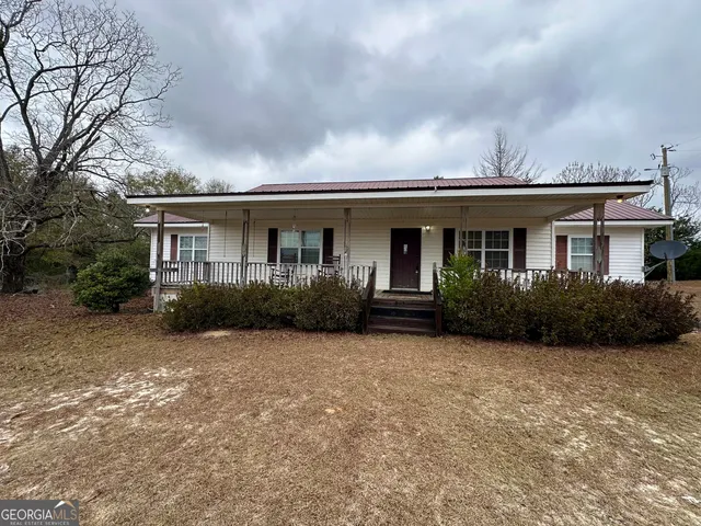 a view of house with yard and green space