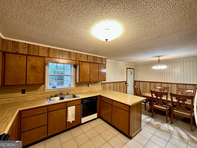 a large kitchen with a large window and counter space
