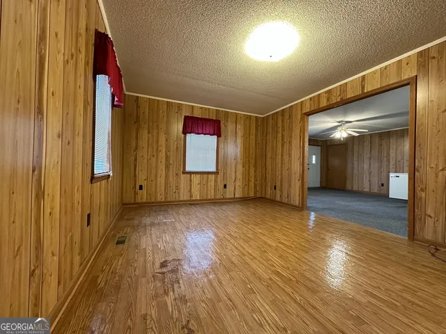 a view of hallway with wooden floor