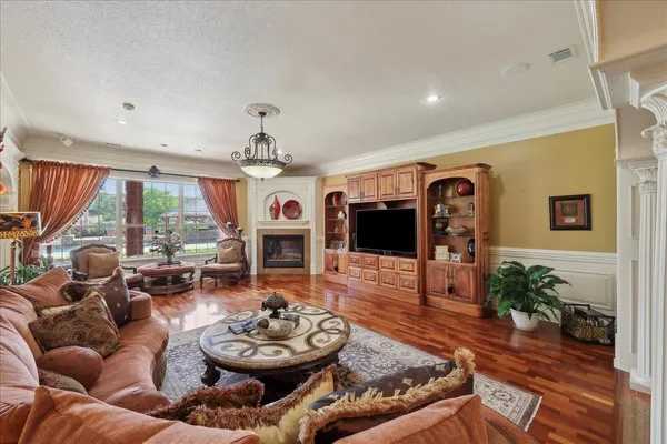 a living room with furniture chandelier and a fireplace