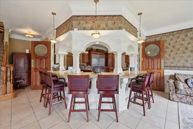 a view of a dining room with furniture and a chandelier