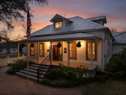 an aerial view of a house with a yard basket ball court and outdoor seating