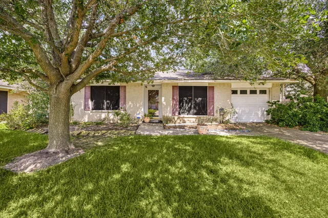 a front view of house with yard and outdoor seating