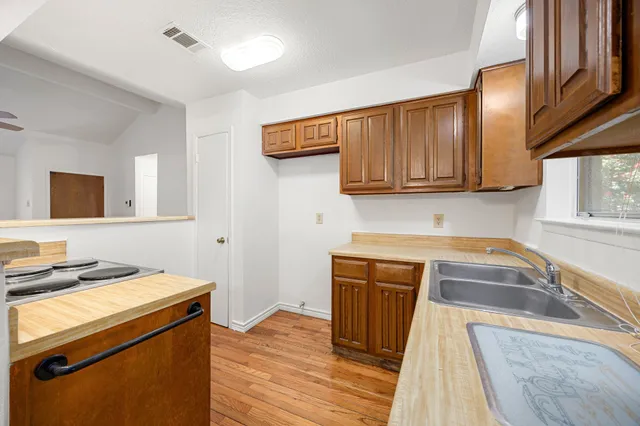 a kitchen with a sink and a stove top oven