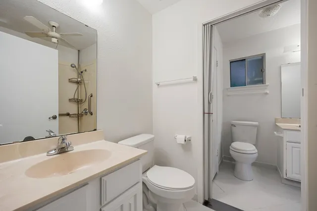 a bathroom with a toilet sink and mirror
