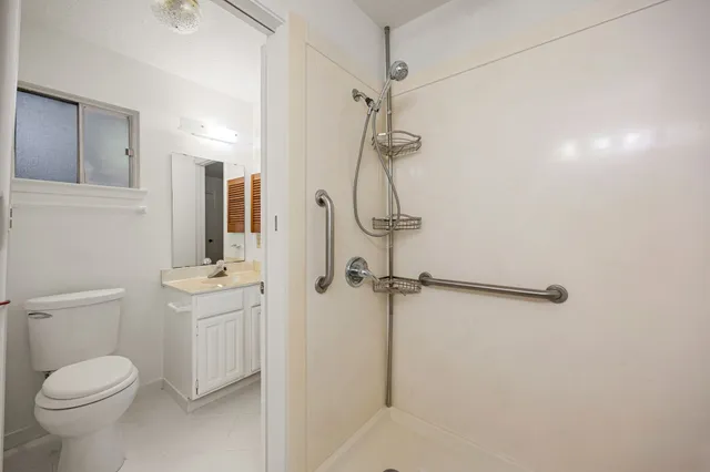 a bathroom with a toilet sink and shower