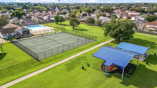 an aerial view of a chairs and table on the green field