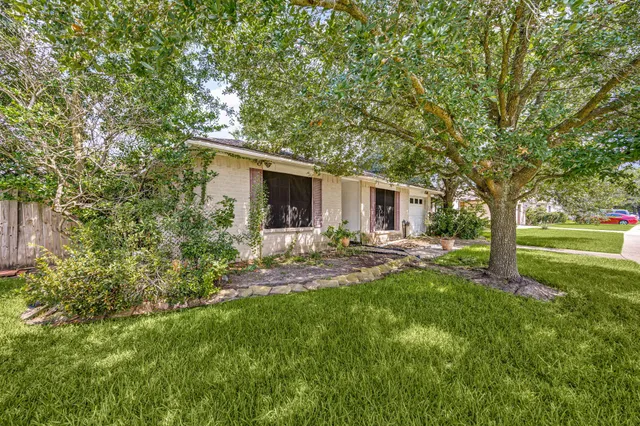 a view of a house with backyard and sitting area