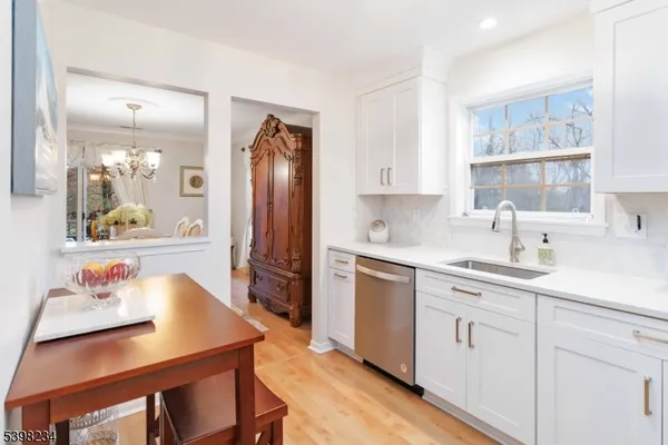 a kitchen with stainless steel appliances a sink a stove a refrigerator and cabinets