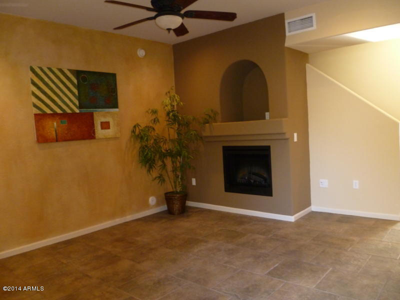 3935 East Rough Rider Road, Unit 1149 Phoenix, AZ 85050 - Photo 13 of 27 Living room w/ Fireplace