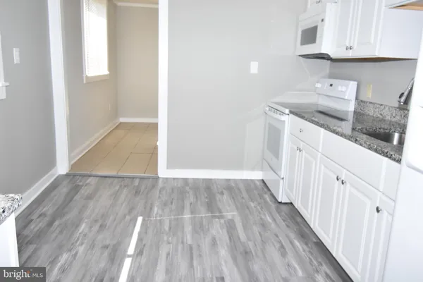 a view of a kitchen from the hallway